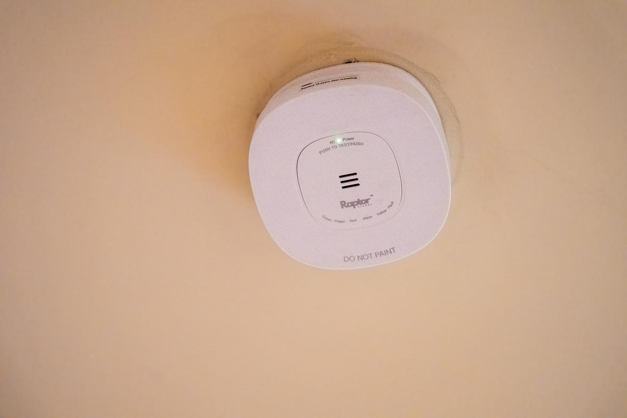 Installed smoke alarm on a Queensland ceiling