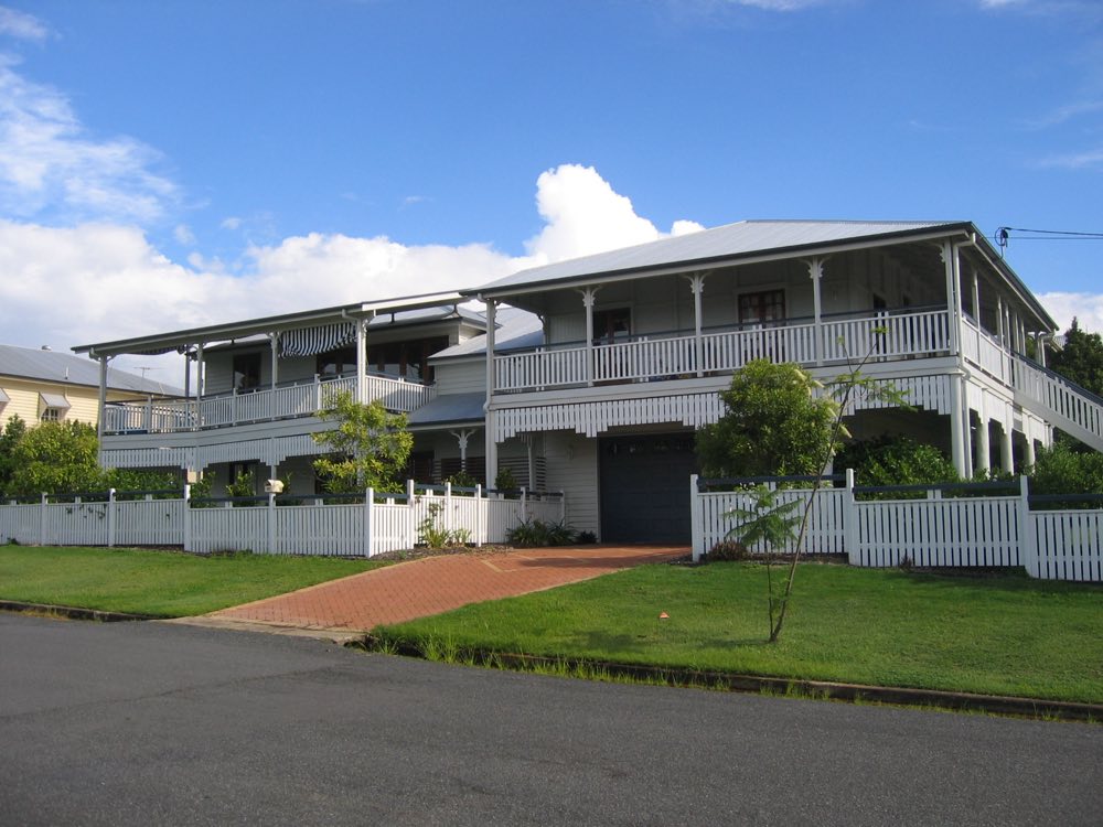 A classic white Queenslander home with wraparound verandah - the kind of Queensland house the 2027 law covers