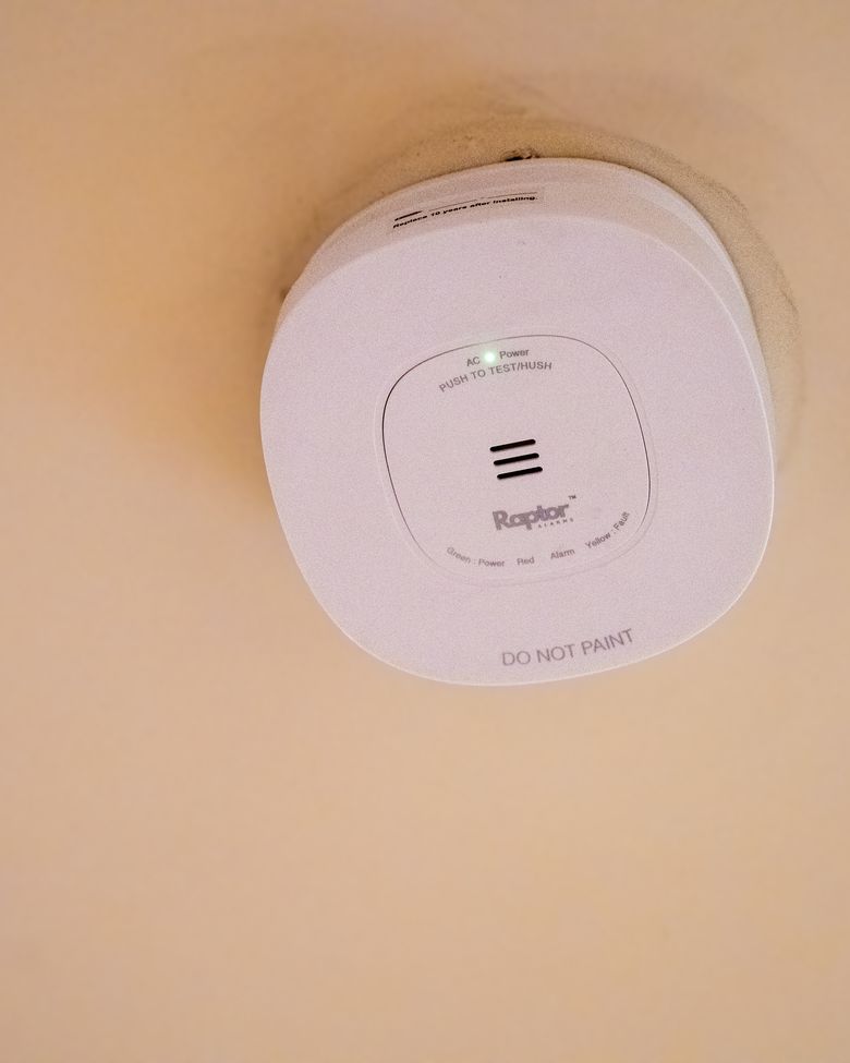 A correctly installed, compliant photoelectric smoke alarm on a Queensland ceiling
